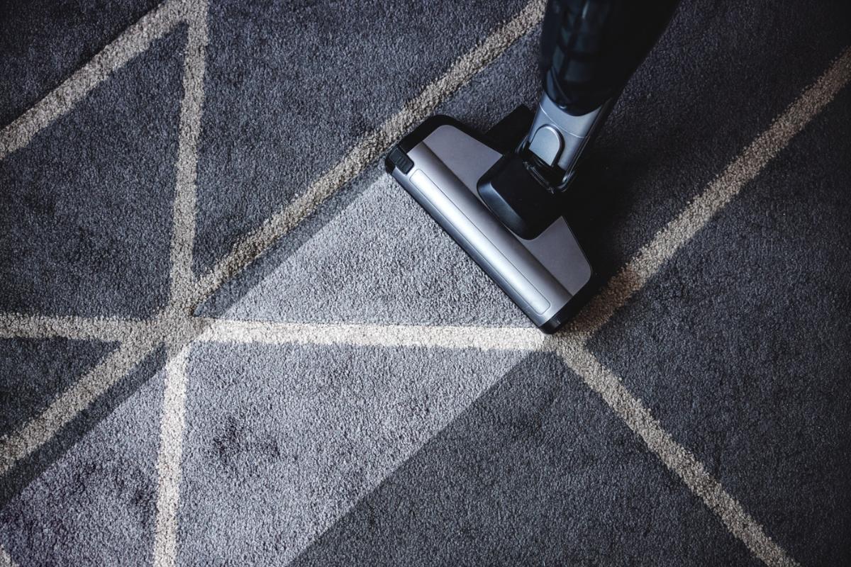 Cleaning solution being worked into a patterned area rug